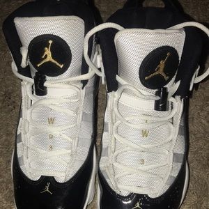 Woman’s size 8 black gold and white Jordan’s
